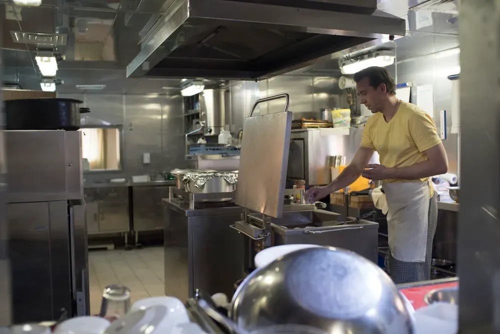 Cook in the ship gallery preparing food