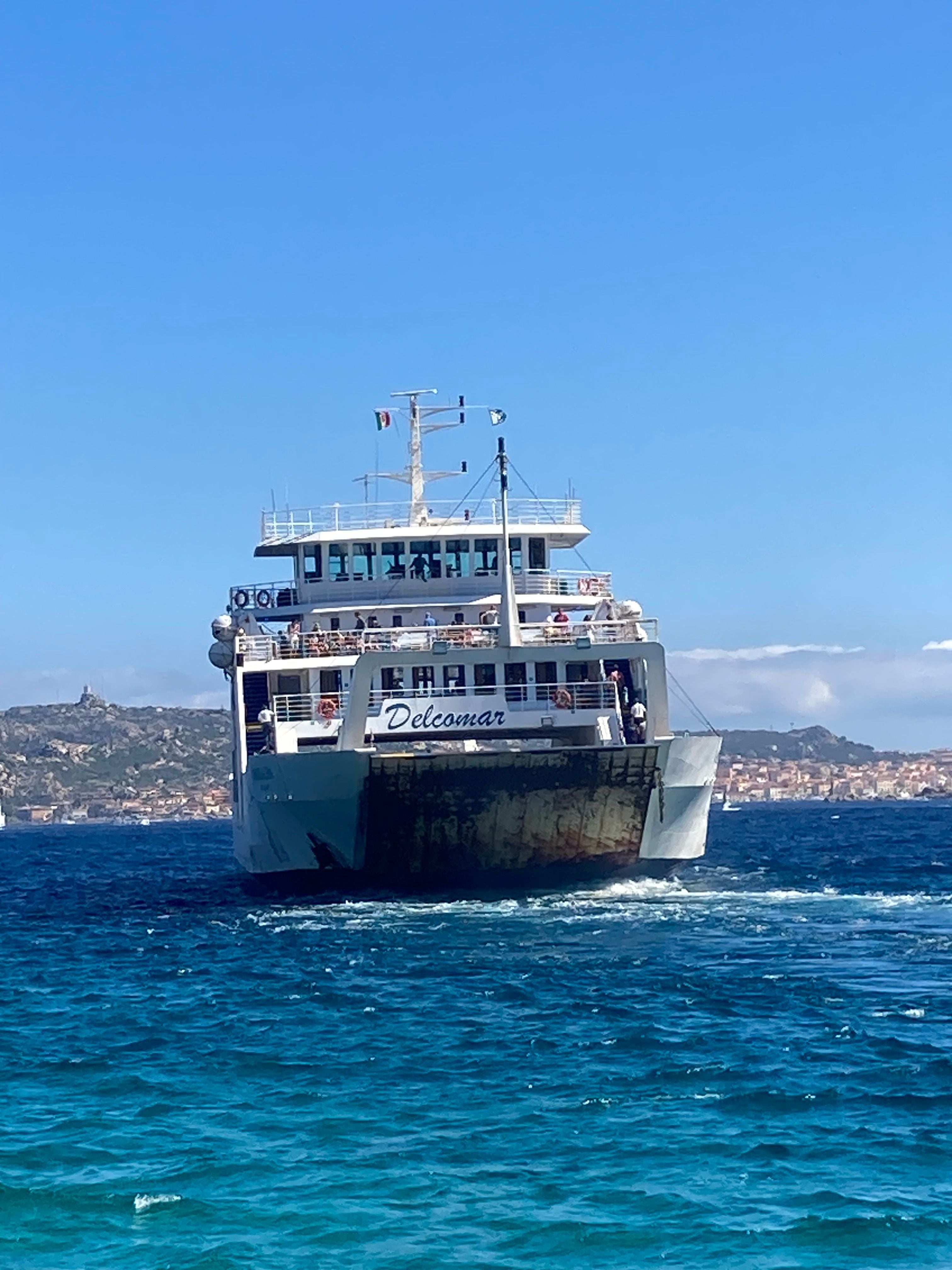 Photograph of a ferry leaving towards a mediterranean island