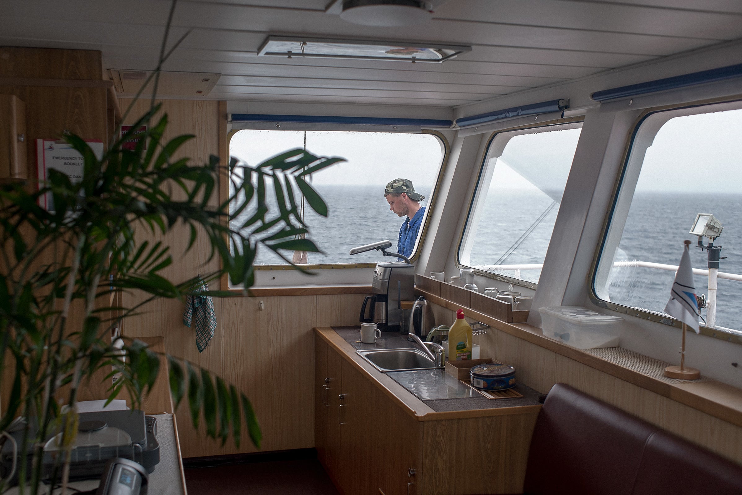 Sailor outside the window of the bridge of the BBC Danube