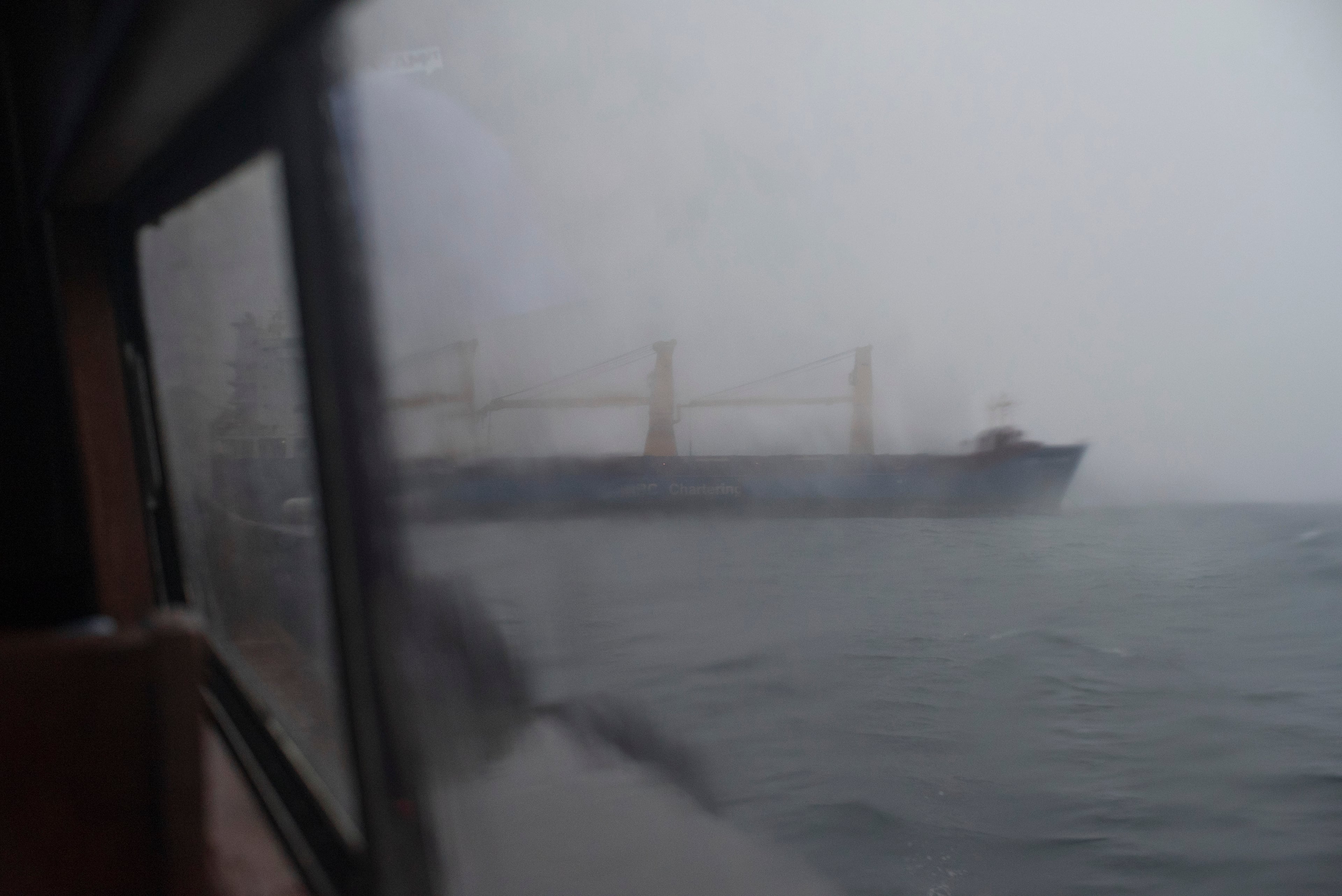 Ship emerging from the rain
