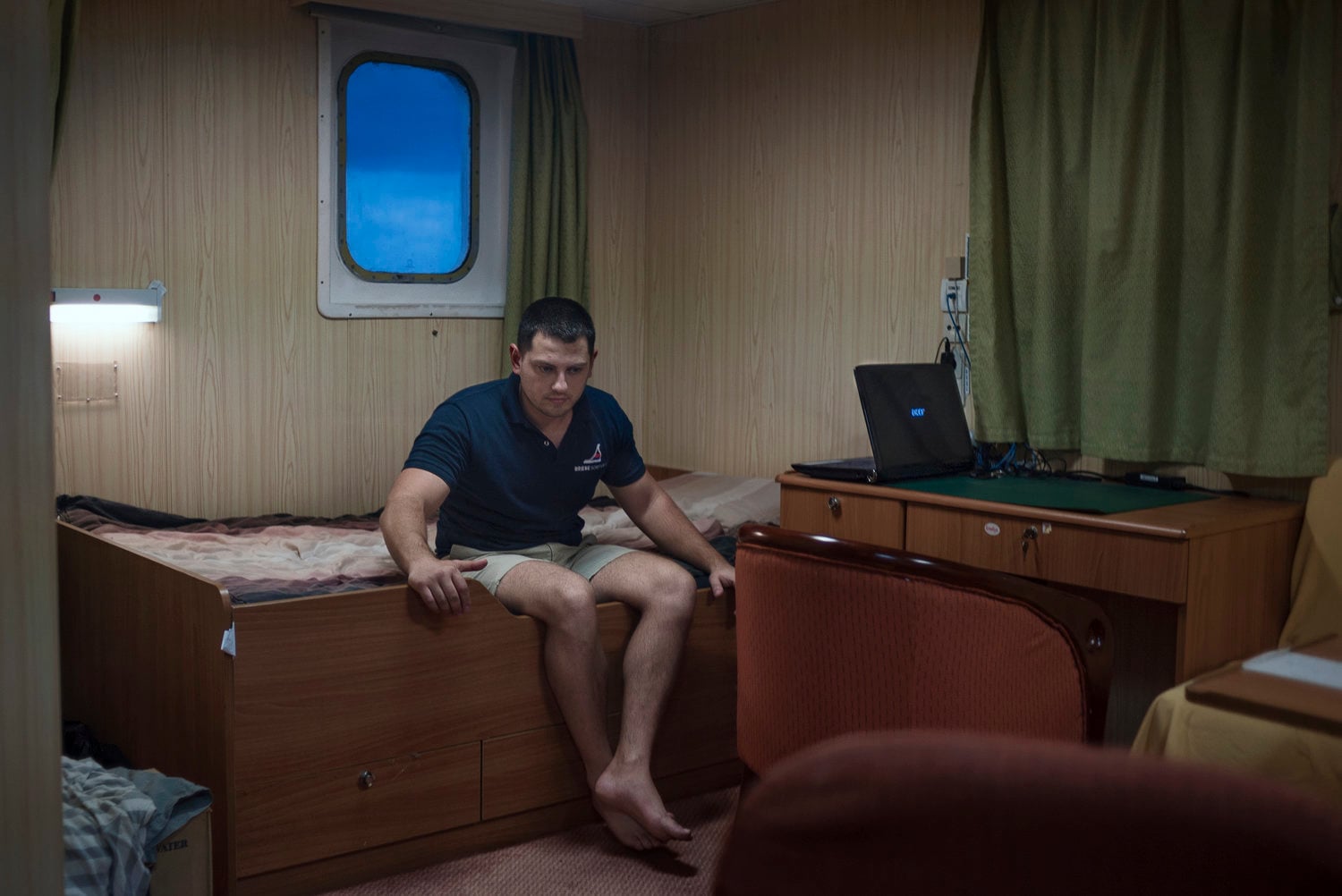 person sitting on a bed on a boat