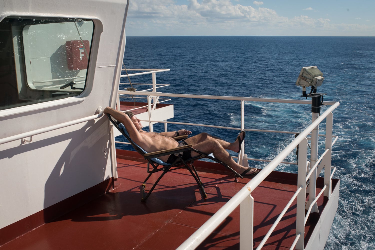 person sunbathing on a boat